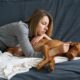 Worried Woman Taking Care Of Her Sick Dog