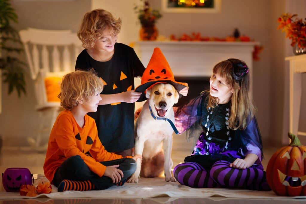 Kids Dressing Up Their Dog For Halloween