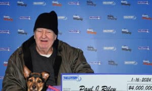 Paul Riley and Raven claiming their lottery prize