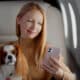 Woman With Dog Using Smartphone In First Class Plane
