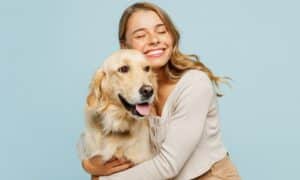 Young smiling happy cheerful owner woman with her best friend retriever